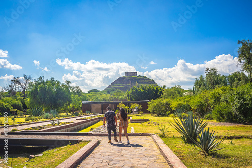 Man and woman walking in the archaeological zone of the Cerrito pyramid in Queretaro