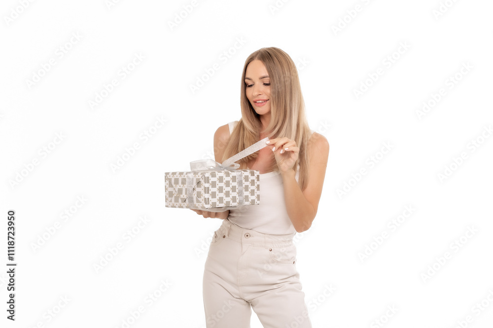 A young woman unwraps a beautifully patterned gift box, smiling with excitement during a joyful occasion A young woman unwraps a beautifully patterned gift box, smiling with excitement during a joyful occasion