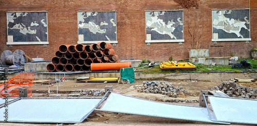 Sticker Mural panels depicting the Roman Empire's conquests at Via del Colosseo, 59, remain partially obscured by ongoing metro construction works near Piazza Venezia