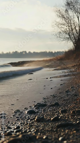 Wallpaper Mural Waves gently lap against a rocky shoreline at sunset while mist rises in the air near a tranquil lake Torontodigital.ca