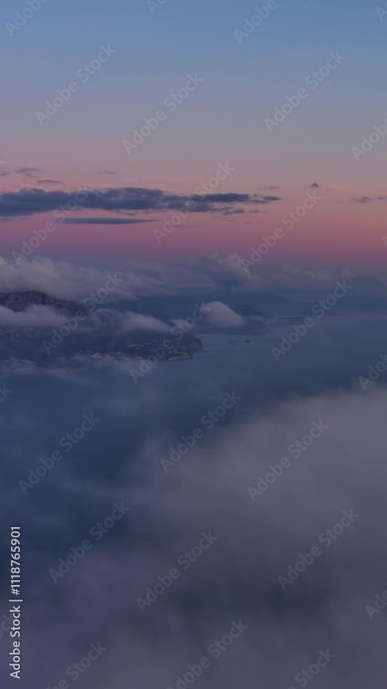 Aerial view on Adriatic sea coast with mountains and Budva city in Montenegro and dusk clouds. Travel seascape background and nature landscape. Vertical video Aerial view on Adriatic sea coast with mountains and Budva city in Montenegro and dusk clouds. Travel seascape background and nature landscape. Vertical video