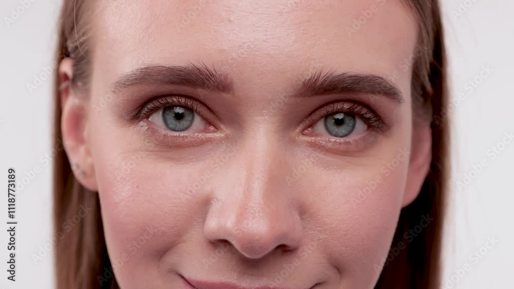 Portrait of attractive girl with healthy clean skin and beautiful make-up. Aesthetic cosmetology and makeup concept.She holds a flower near her face Portrait of attractive girl with healthy clean skin and beautiful make-up. Aesthetic cosmetology and makeup concept.She holds a flower near her face