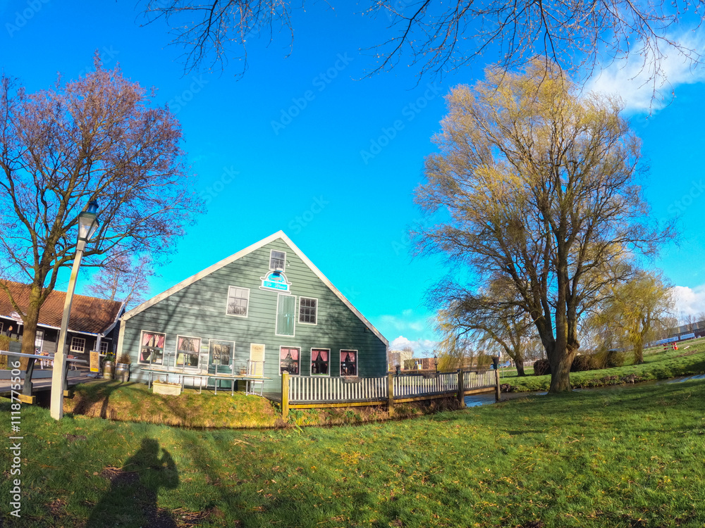 Zaanse Schans, Netherlands, March 29 2023: Traditional wooden houses specific to the Dutch style. Brightly colored ancient houses in the village Zaanse Schans, Netherlands, March 29 2023: Traditional wooden houses specific to the Dutch style. Brightly colored ancient houses in the village