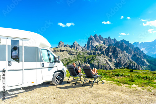 Family enjoying panoramic view of tre cime di lavaredo from camper van