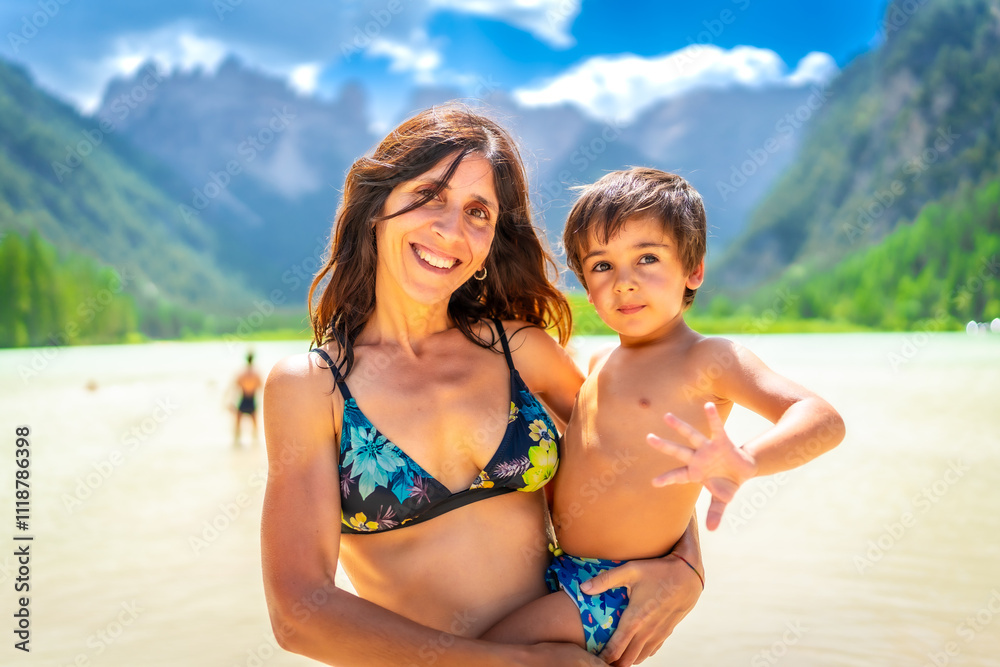 Mother and son enjoying summer swim in the dolomites at lago di landro Mother and son enjoying summer swim in the dolomites at lago di landro