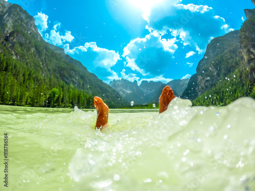 Tourist relaxing in the turquoise water of lago di landro in the dolomites, italy photo