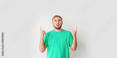Surprised young man pointin...