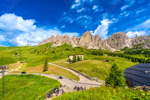 Passo gardena winding road leading to dolomites group mountains in summer photo