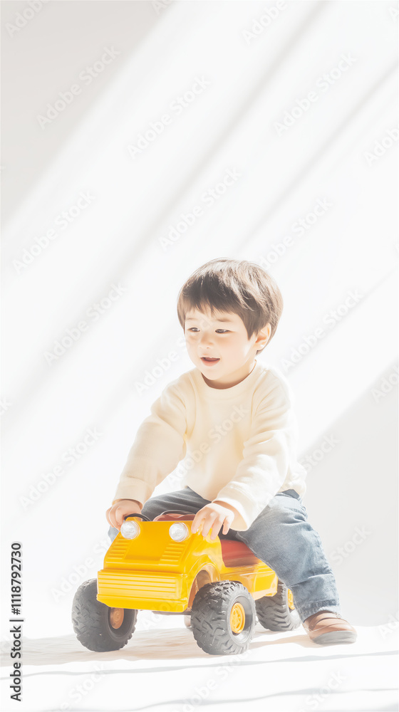 Adorable toddler playing with a bright yellow toy car, seated indoors on a clean, minimal background, capturing innocence, playfulness, and early childhood joy. Adorable toddler playing with a bright yellow toy car, seated indoors on a clean, minimal background, capturing innocence, playfulness, and early childhood joy.