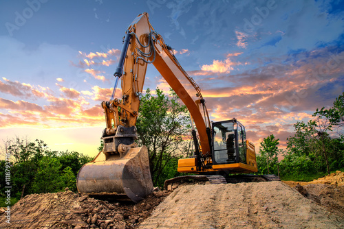 A stopping yellow excavator at an incredibly beautiful sunset