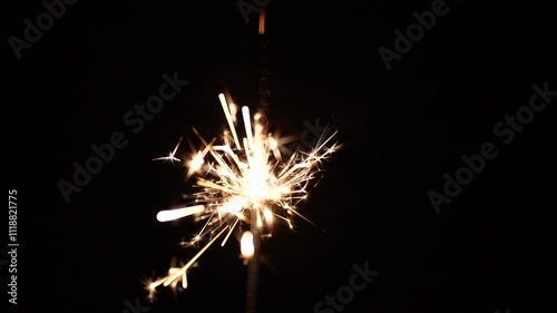 Sparkler candle on a black background. The concept of the New Year and holidays