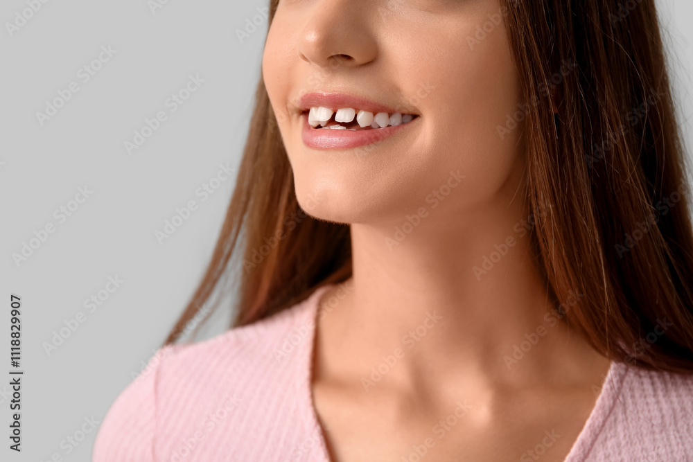Young woman with diastema smiling on light background, closeup Young woman with diastema smiling on light background, closeup