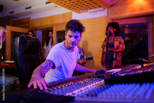 Принти на полотні Portrait of sound technician operating channel mixer at recording studio