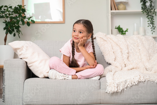 Thoughtful little girl sitt...