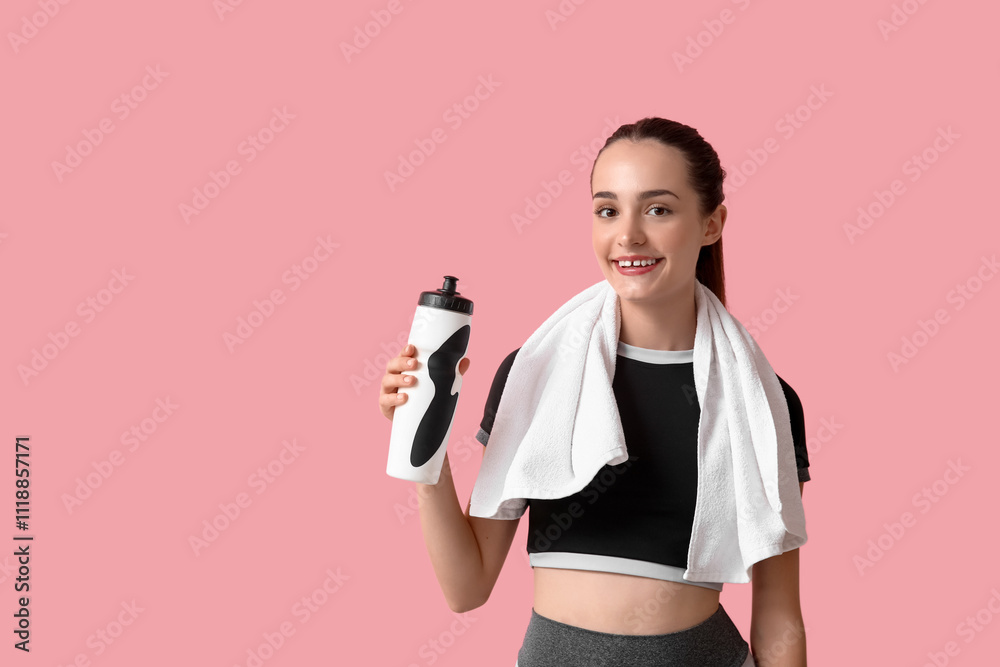 Beautiful young sporty happy woman with bottle of water and towel on pink background Beautiful young sporty happy woman with bottle of water and towel on pink background