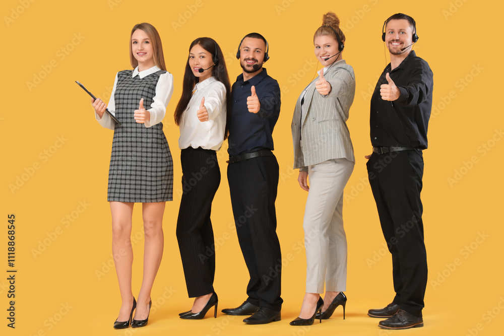 Fototapeta premium Technical support agents showing thumbs-up on yellow background