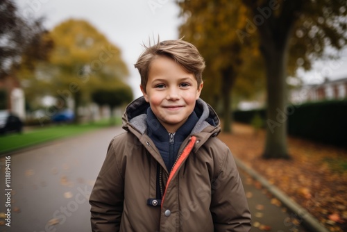 Portrait of a cute little boy in a coat in the autumn park