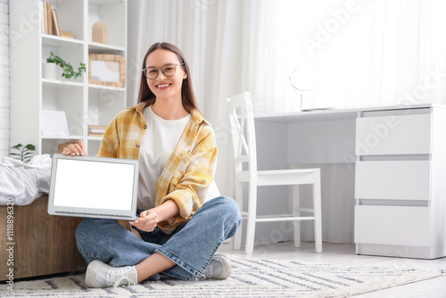 Young woman with blank lapt...