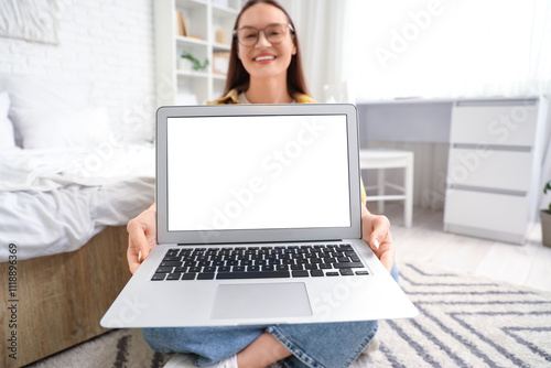 Young woman with blank lapt...