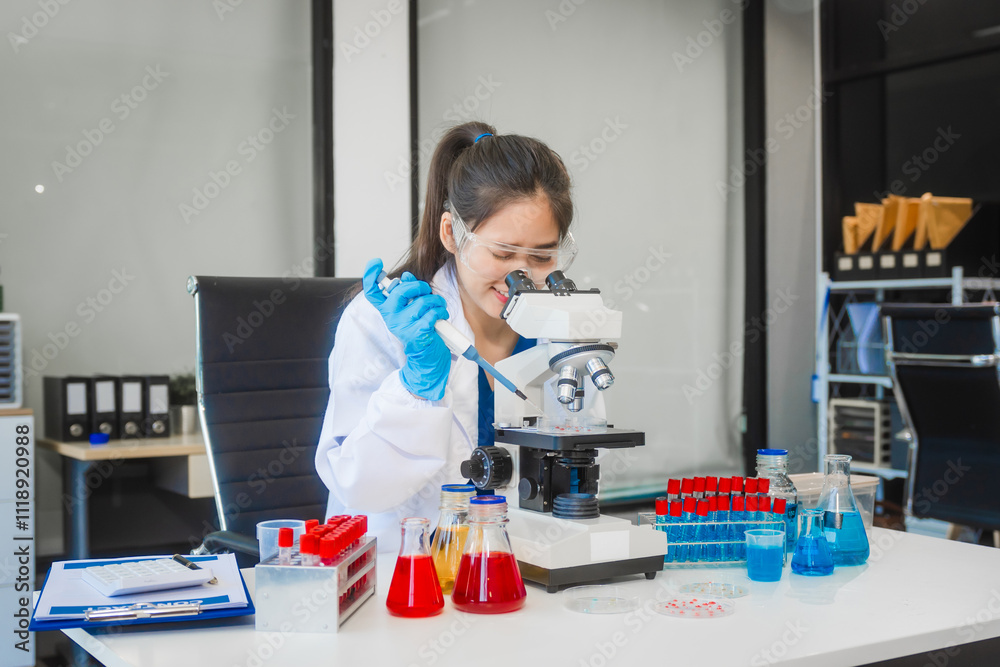A young Asian woman works in a laboratory, conducting chemical and blood tests. Wearing goggles, research and analysis, combining science and technology in a professional and medical environment. A young Asian woman works in a laboratory, conducting chemical and blood tests. Wearing goggles, research and analysis, combining science and technology in a professional and medical environment.
