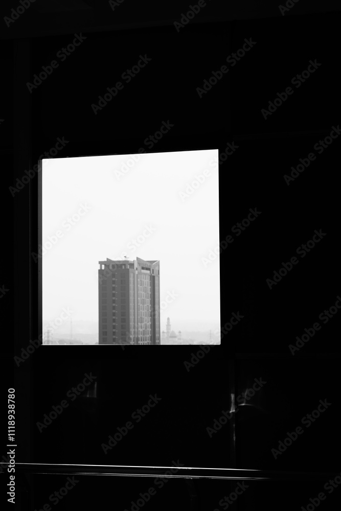 Peeking at a tall building from behind a hole in the window of a multi-storey building Peeking at a tall building from behind a hole in the window of a multi-storey building