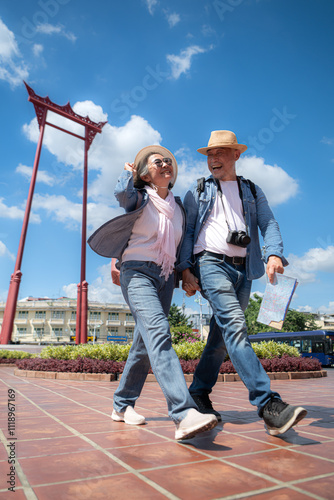 Photography An elderly couple walks around the street in the old city of Bangkok, Thailand