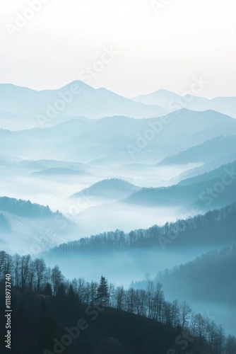 Serene mountain landscape shrouded in mist and soft blue hues.