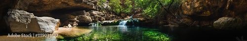 Lush Green Waterfall Cascading Down Rocky Cliffs