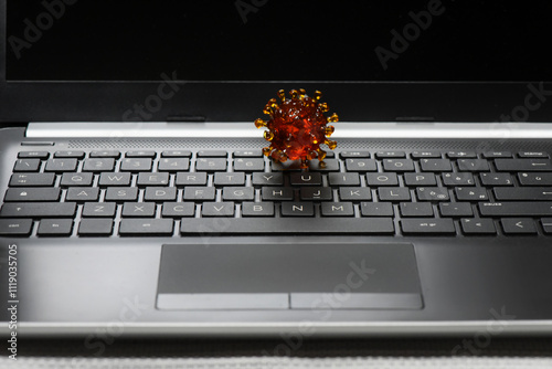 covid virus on a keyborad of a laptop photo