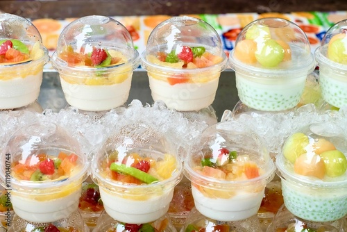 Tapioca pudding with coconut cream and fresh fruit (melon, strawberry, kiwi, orange) for sale at Soi 20, an open street market selling fresh produce and street food in Silom - Bang Rak, Bangkok photo