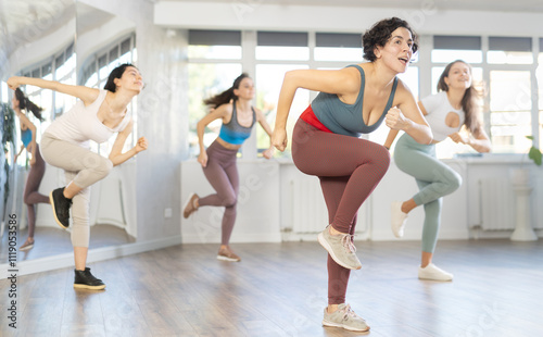 Group of women rehearsing dancehall dance moves in studio