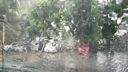 Rainy view from car windshield with wipers on