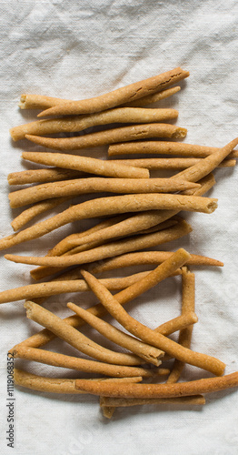 Top view of fried corn stick snack on a linen napkin, Overhead view of nigerian kokoro corn snack photo