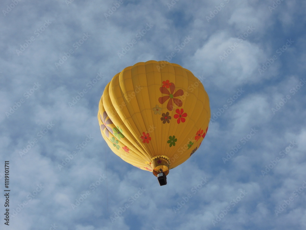 Fototapeta premium Yellow hot air balloon flying in the sky, Erie, Colorado