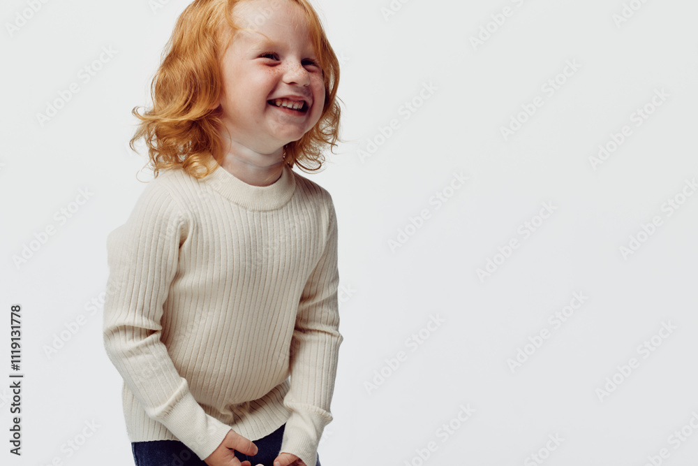 Laughing little girl in white sweater on white background expressing joy and happiness for fashion and beauty magazine Laughing little girl in white sweater on white background expressing joy and happiness for fashion and beauty magazine