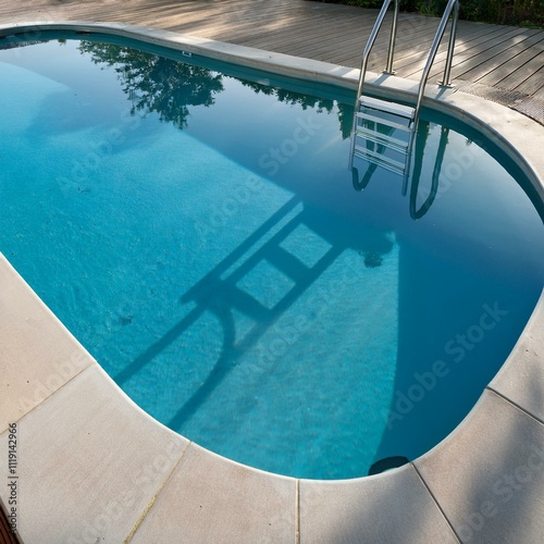 Stylish oval swimming pool surrounded by a concrete deck, featuring a polished metal ladder, perfect for contemporary outdoor relaxation