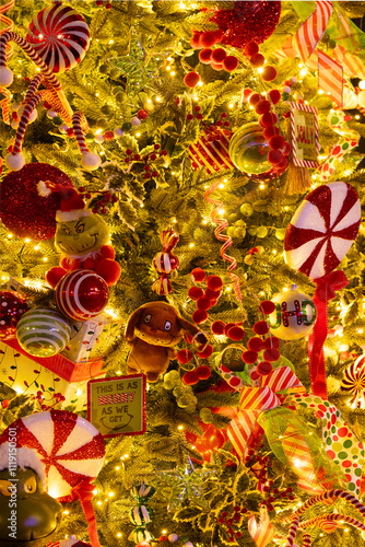 Christmas tree decorated with ribbons and fabric, candies and lights.