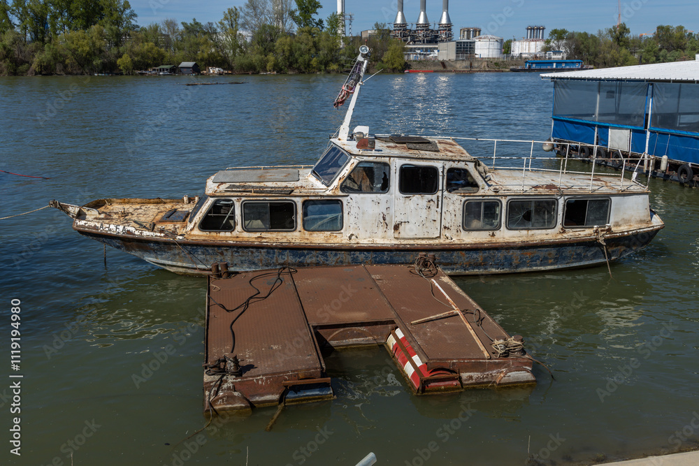 Boat is sitting in the water next to a dock Boat is sitting in the water next to a dock