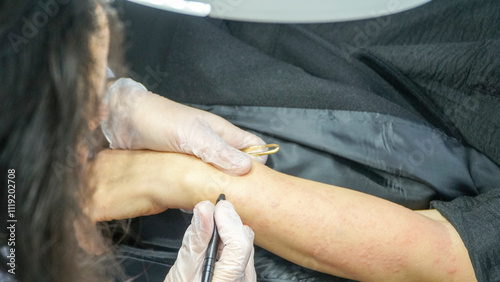 Professional woman performing needle epilation