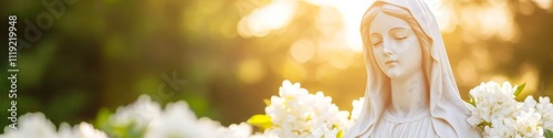 Serene Garden Statue of Virgin Mary with Blooming Flowers in Soft Sunlight