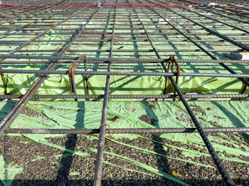 Close-up of a steel mesh structure use as a reinforcement of concrete in a construction project. photo