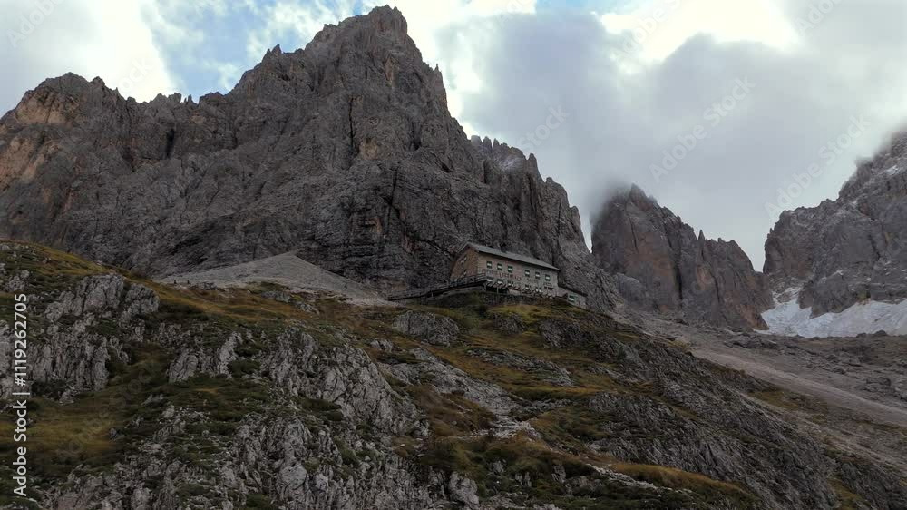 Langkofelhütte Rifugio Vicenza rests beneath the towering Langkofel (Sassolungo) peaks in the Dolomites. Surrounded by dramatic cliffs, this alpine refuge offers a unique escape for hikers. Langkofelhütte Rifugio Vicenza rests beneath the towering Langkofel (Sassolungo) peaks in the Dolomites. Surrounded by dramatic cliffs, this alpine refuge offers a unique escape for hikers.