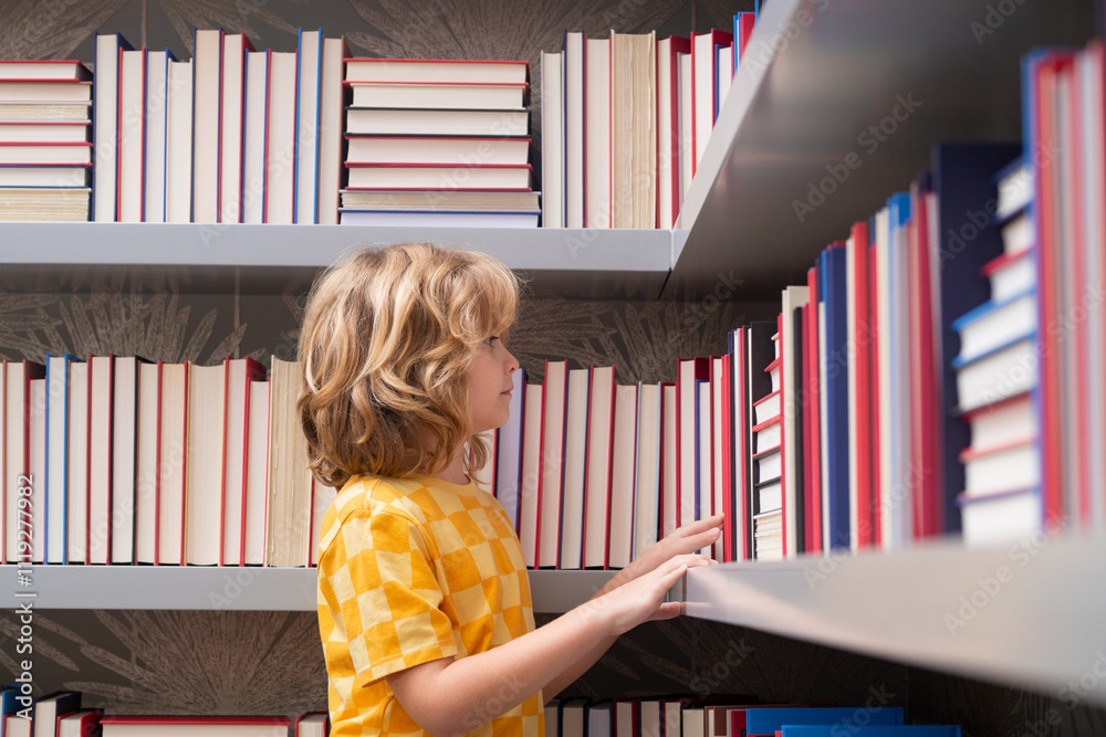 © Volodymyr - School boy. Pupil with pile of books. Children enjoying book story in school library. Kids imagination, interest to literature. Kids clever. Child study read book in class.