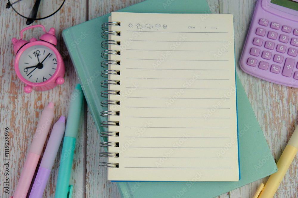flat lay of a blank note book for text space. Educational concept with text space on pink background. flat lay of a blank note book for text space. Educational concept with text space on pink background.