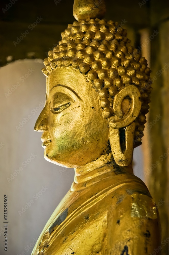Golden Buddha statue in a temple in Luang Prabang, Laos