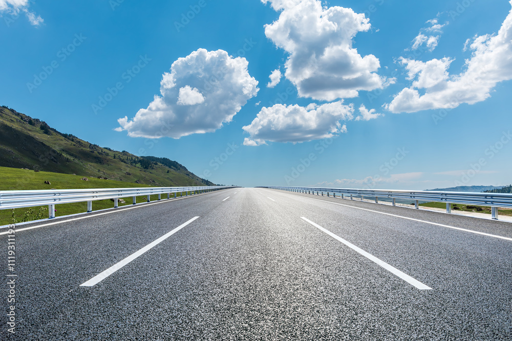 Fototapeta premium Asphalt highway road and mountain nature landscape under blue sky. Outdoor road background.
