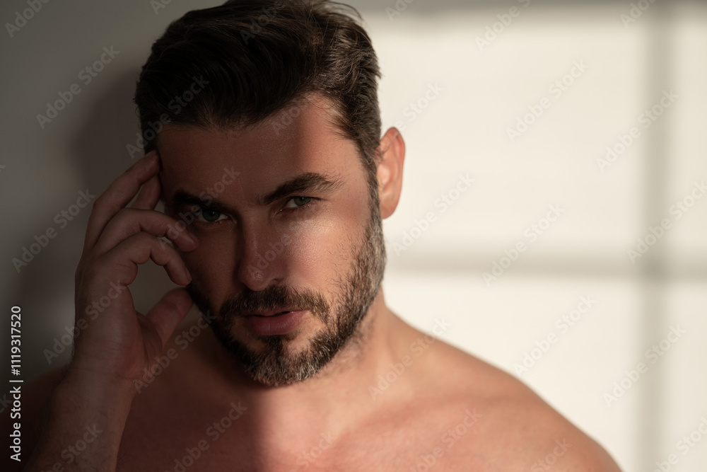 Closeup portrait of attractive man for cream on male face cosmetics advertising. Beautiful man close up portrait on white background. Naked shoulders, skin care, health, cosmetics for skin. Closeup portrait of attractive man for cream on male face cosmetics advertising. Beautiful man close up portrait on white background. Naked shoulders, skin care, health, cosmetics for skin.