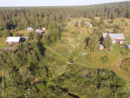 A rural area with a small house and a barn photo