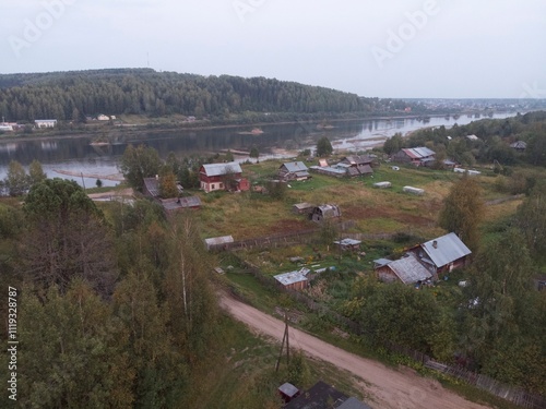 A rural area with a small house and a barn photo