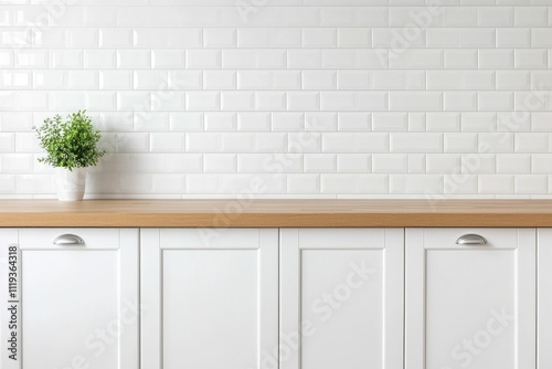 White kitchen cabinets with wood countertop and plant against white subway tile backsplash.